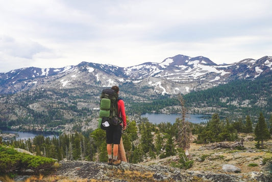 man-with-backpack-looking-at-the-mountain