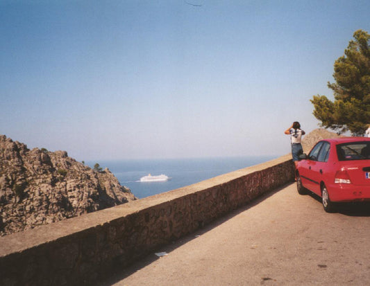 red-car-on-the-road-sea-view