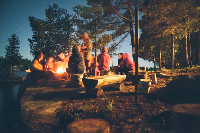 people-gathering-near-fire-in-forest